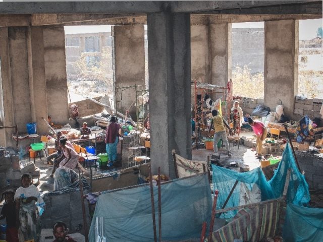 Hundreds of people in Shire’s University IDP site live in an unfinished building, where they sleep, cook and eat. Many don’t have mattresses or blankets. ©Claudia Blume/MSF